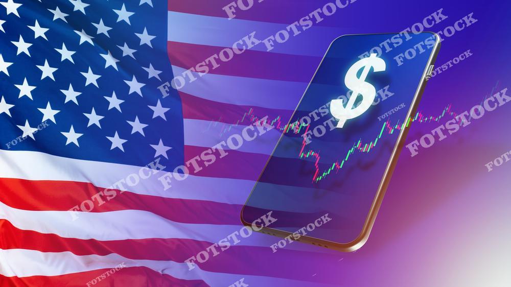 На изображении смартфон с графиком роста и символом доллара, расположенный на фоне американского флага. Это отражает динамику финансов и экономику США, а также использование современных технологий для инвестирования и анализа рынка.