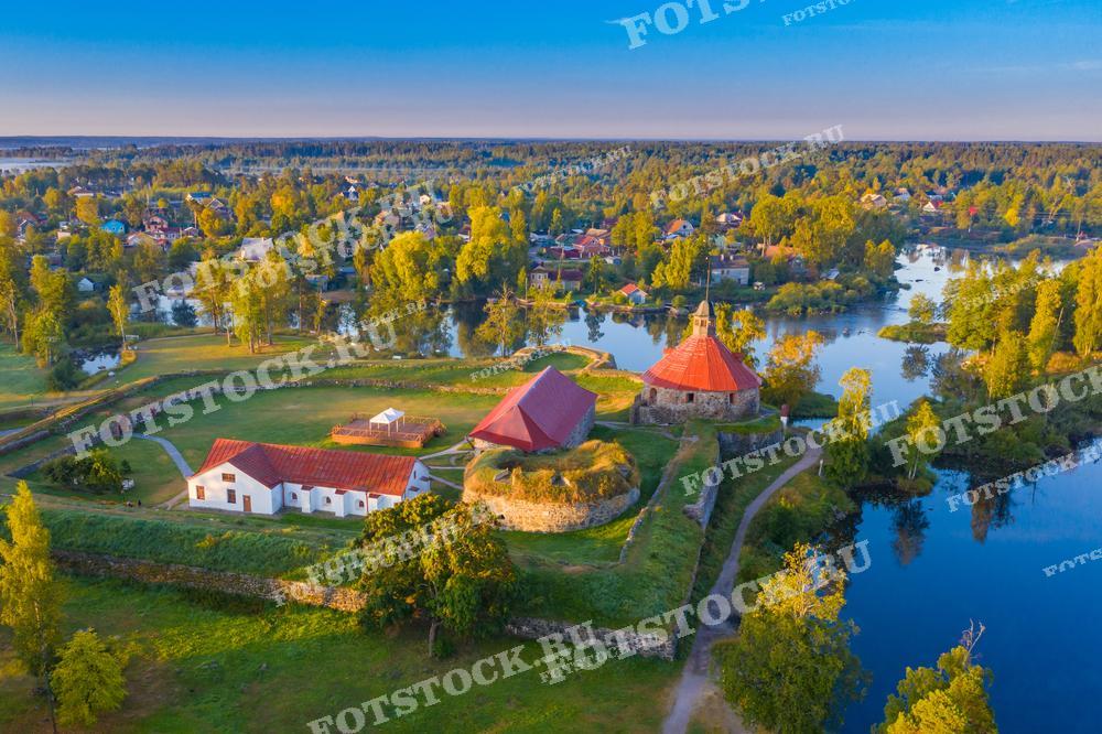 На фотографии изображена крепость Корела в Приозерске, Карелия. Снимок сделан с высоты, что позволяет увидеть окружающие постройки и природу.