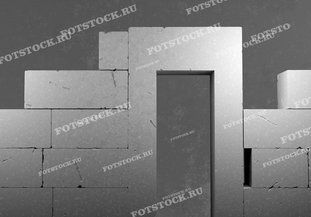 На фотографии изображена кирпичная кладка с проемом под дверь. Кирпичи или блоки уложены ровными рядами, создавая структуру будущей стены здания.