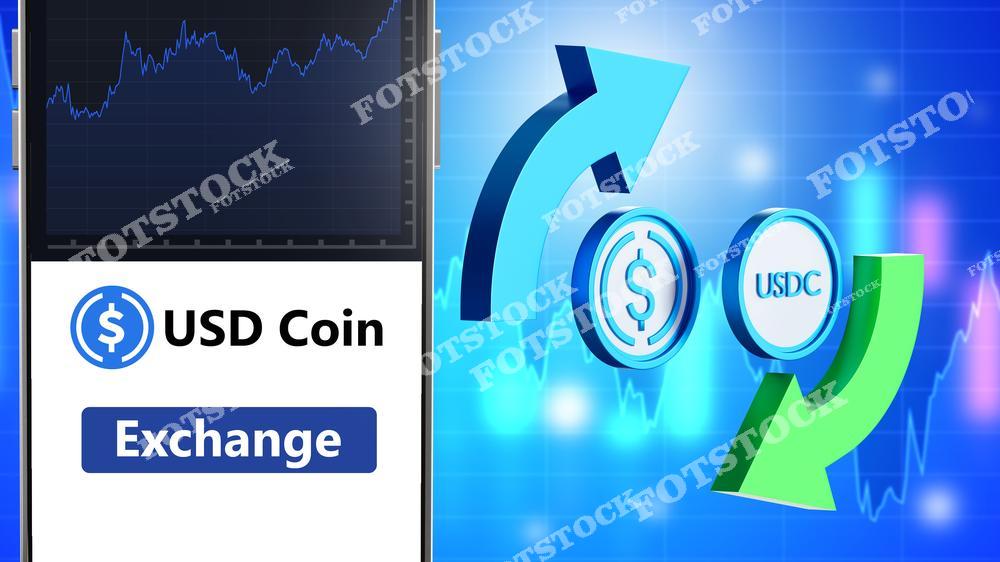 На изображении показан процесс обмена USD Coin (USDC) с символами стрелок, указывающими движение, и графиком на фоне. Это символизирует операции с криптовалютой и стейблкоинами на цифровых биржах. Фотография отражает важность USDC в мире финансовых технологий и цифровой торговли.